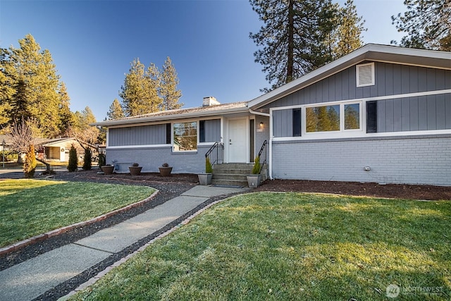 ranch-style house with a front lawn