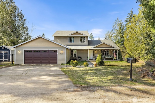 traditional home with a garage, a front yard, covered porch, and concrete driveway