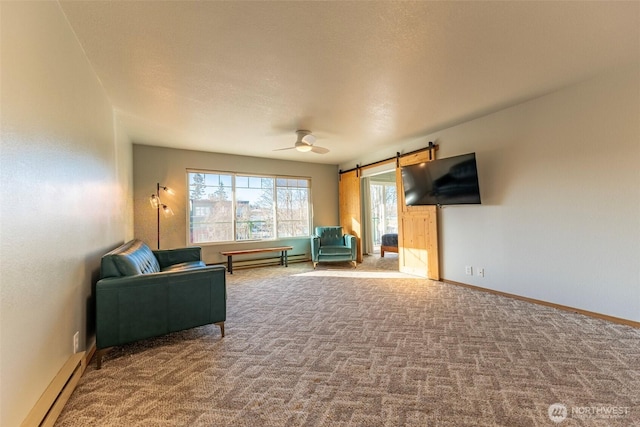 sitting room with carpet flooring, a textured ceiling, ceiling fan, a barn door, and baseboard heating