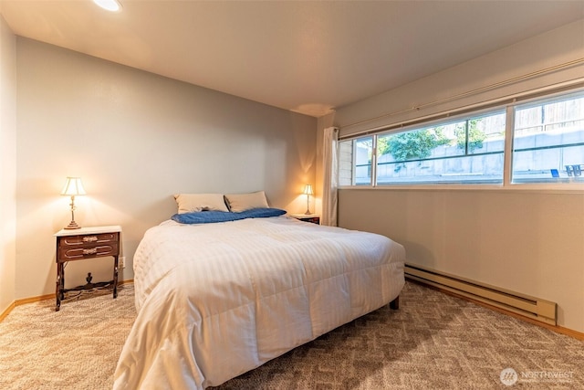 bedroom featuring baseboard heating and carpet floors