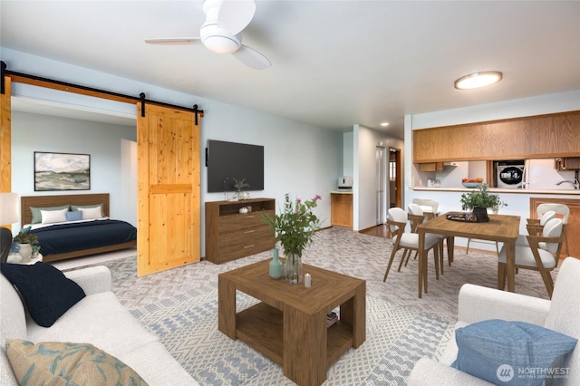 230 B St Unit 102, Friday Harbor, WA 98250 - living room with a barn door, washer / dryer, and a ceiling fan