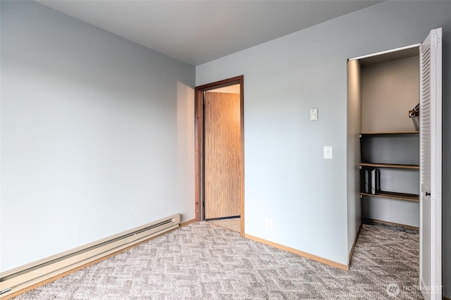 230 B St Unit 102, Friday Harbor, WA 98250 - unfurnished bedroom featuring baseboard heating, carpet, and baseboards