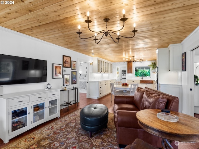 living room featuring wood-type flooring, ornamental molding, wooden ceiling, and a chandelier