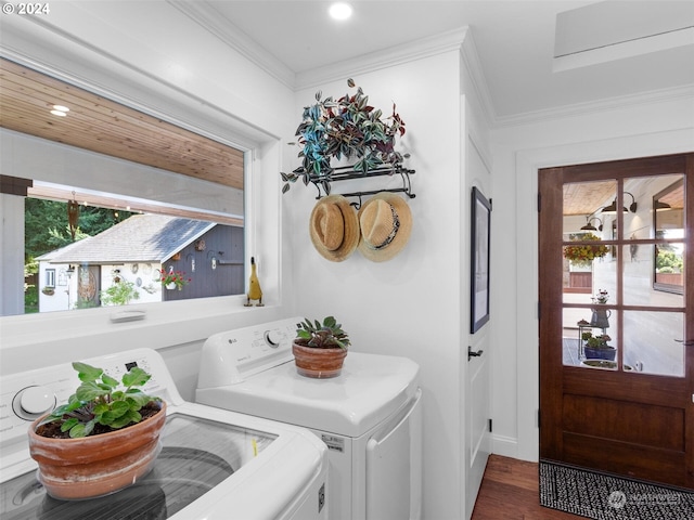 laundry room featuring washer and clothes dryer, ornamental molding, and dark hardwood / wood-style floors