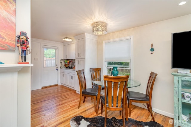 dining space with light hardwood / wood-style floors