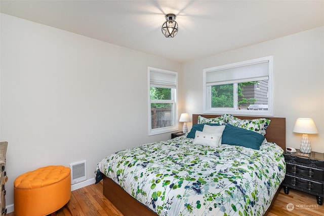 bedroom with hardwood / wood-style flooring