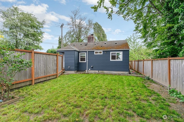 rear view of house with a lawn