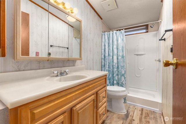 bathroom featuring walk in shower, vanity, toilet, and hardwood / wood-style flooring