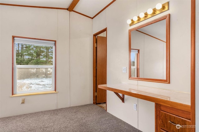 interior space featuring lofted ceiling with beams and carpet