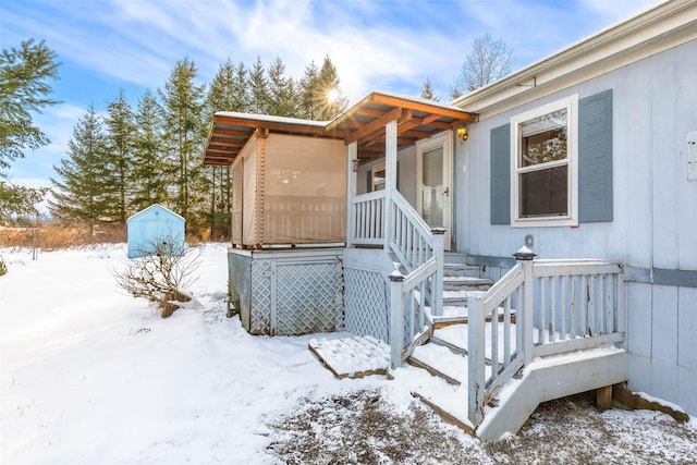 view of snow covered property entrance