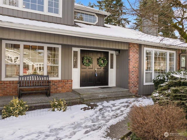 view of snow covered property entrance