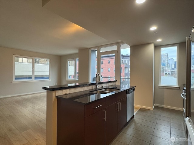 kitchen featuring dishwasher, sink, and dark brown cabinets