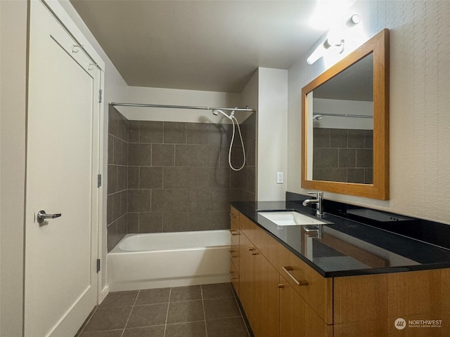 bathroom with tiled shower / bath combo, vanity, and tile patterned flooring