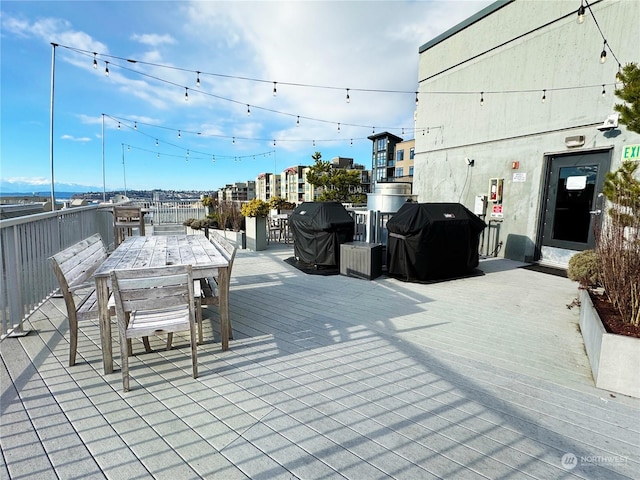 wooden deck featuring a grill