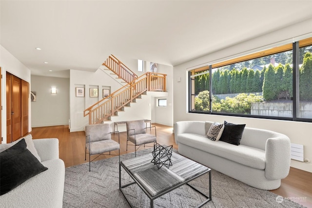 living room with plenty of natural light and light hardwood / wood-style flooring