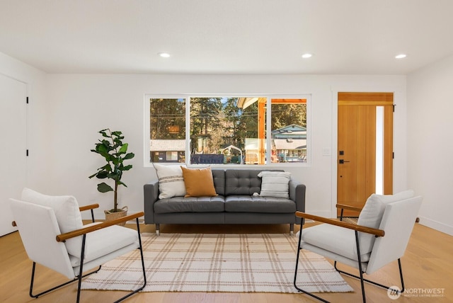 living area with recessed lighting, light wood-style floors, and baseboards