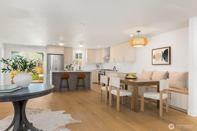 dining area featuring light wood-style flooring