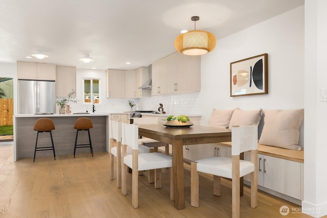 dining space with recessed lighting and light wood-type flooring