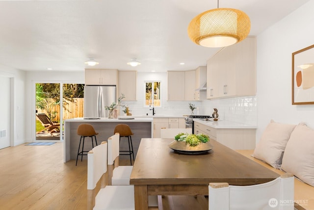 dining room featuring recessed lighting and light wood-style floors