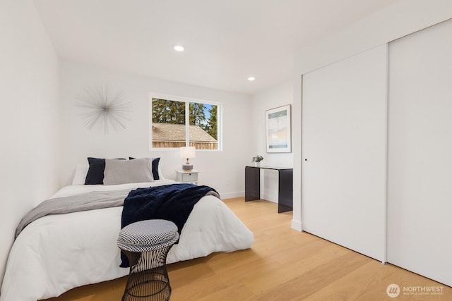 bedroom with recessed lighting and light wood-type flooring