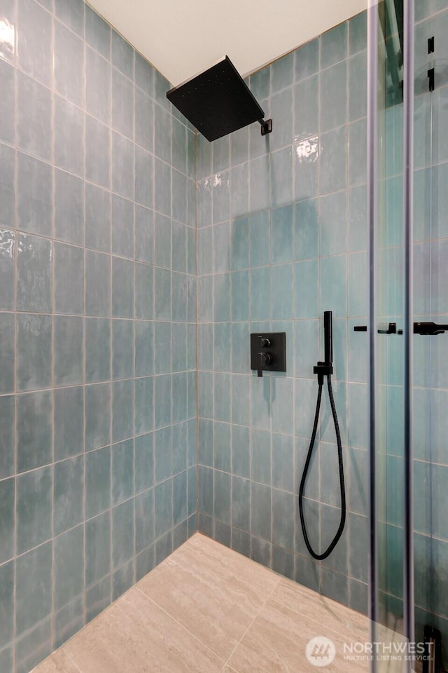 full bathroom with a tile shower