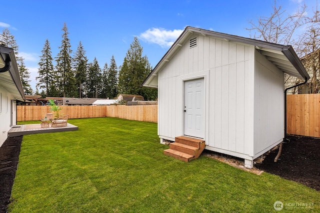 view of outbuilding featuring a fenced backyard and an outdoor structure