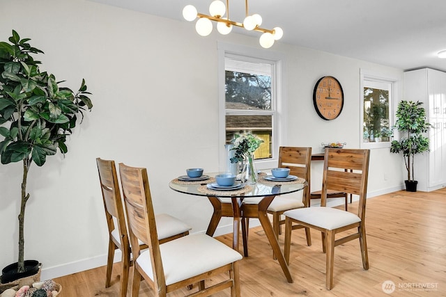 dining room featuring a chandelier and light hardwood / wood-style flooring