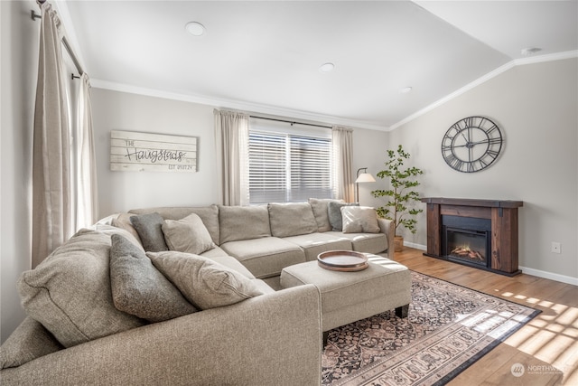 living room featuring crown molding, vaulted ceiling, and hardwood / wood-style floors