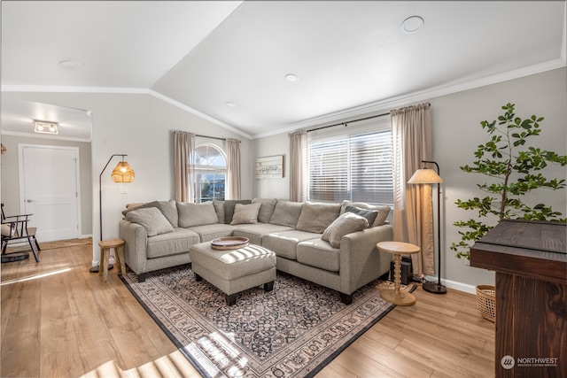 living room with crown molding, vaulted ceiling, and light hardwood / wood-style flooring