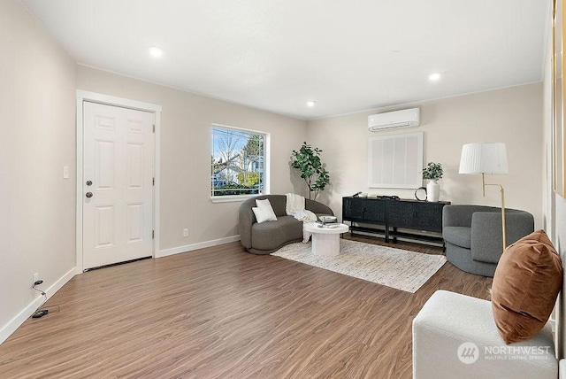 living room featuring hardwood / wood-style flooring and a wall mounted AC