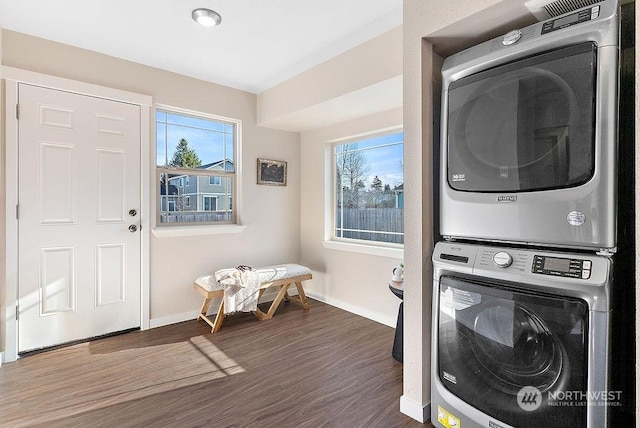 washroom with stacked washer and clothes dryer and dark hardwood / wood-style flooring