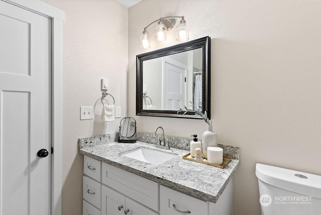 bathroom with vanity and toilet