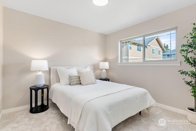 bedroom featuring light carpet