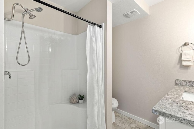 bathroom featuring walk in shower, vanity, and toilet