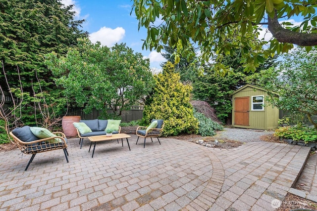 view of patio / terrace featuring an outbuilding, a storage unit, and fence