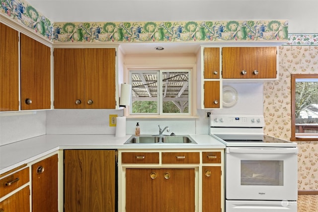 kitchen featuring plenty of natural light, sink, and white electric range