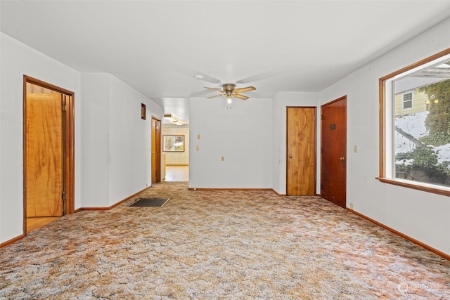 spare room featuring ceiling fan and carpet flooring