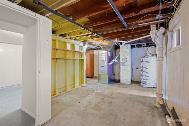 basement featuring heating unit and gas water heater