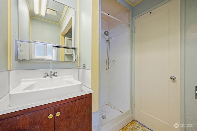 bathroom featuring walk in shower and vanity