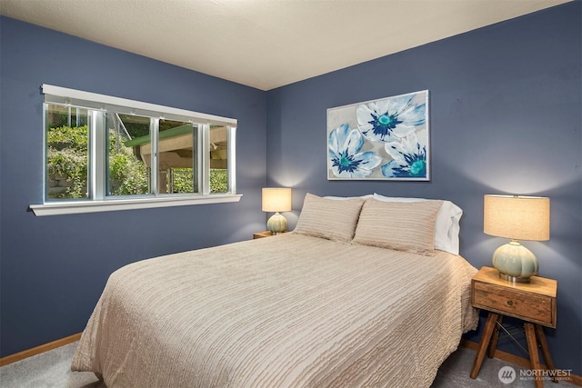 bedroom with dark colored carpet