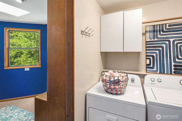 laundry area with cabinets, separate washer and dryer, carpet floors, and a skylight