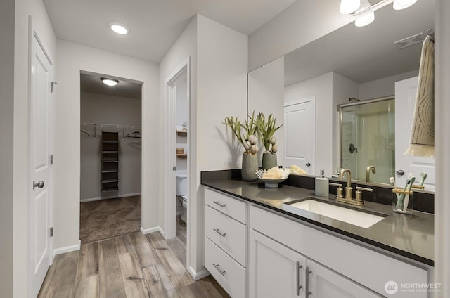 288 Wind River Ct, Chehalis, WA 98532 - bathroom with toilet, wood-type flooring, vanity, and a shower with shower door