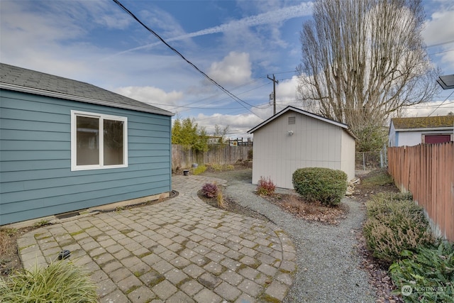 view of side of property featuring an outbuilding and a patio area