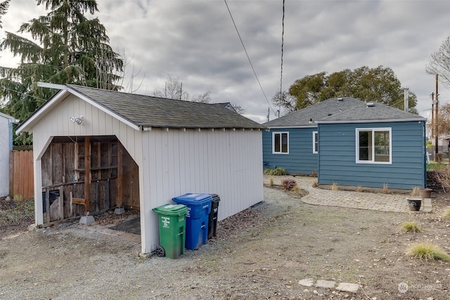 rear view of house with an outdoor structure