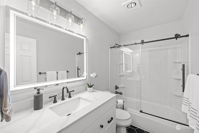 full bathroom with bath / shower combo with glass door, vanity, and toilet