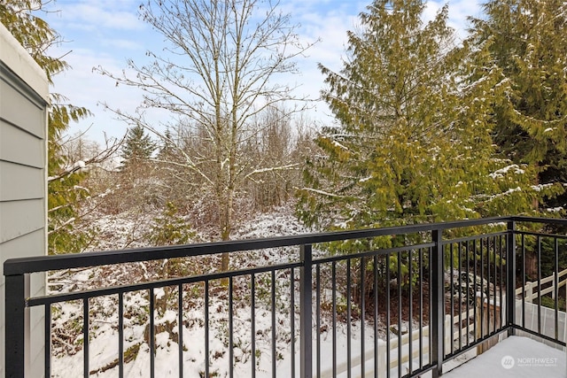 view of snow covered back of property