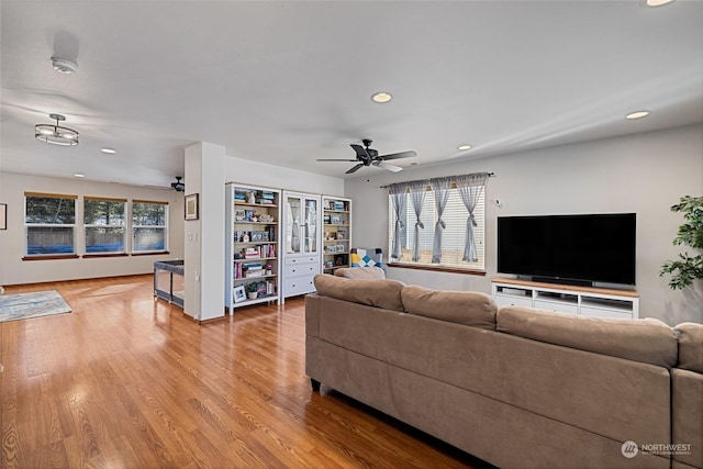 living room featuring hardwood / wood-style flooring and ceiling fan