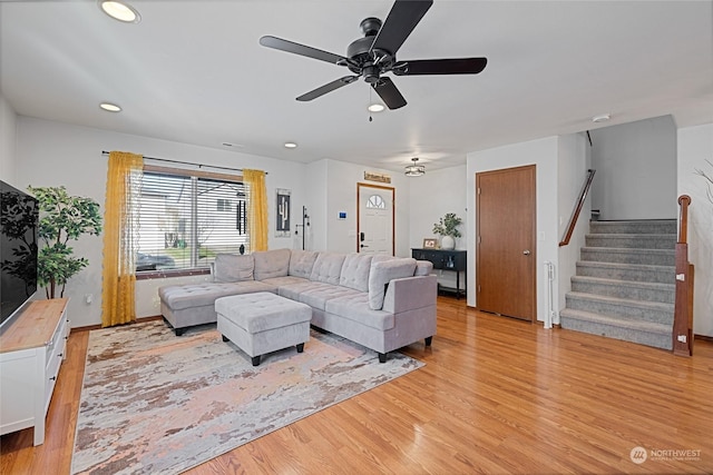 living room with ceiling fan and light wood-type flooring