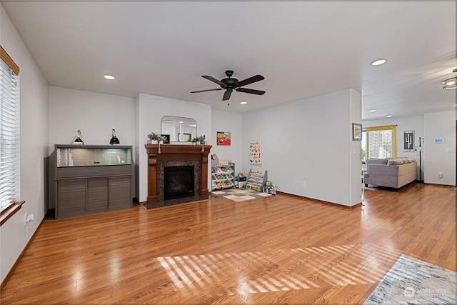 living room with ceiling fan and light hardwood / wood-style floors