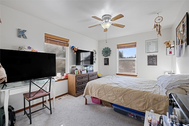 bedroom featuring light carpet and ceiling fan